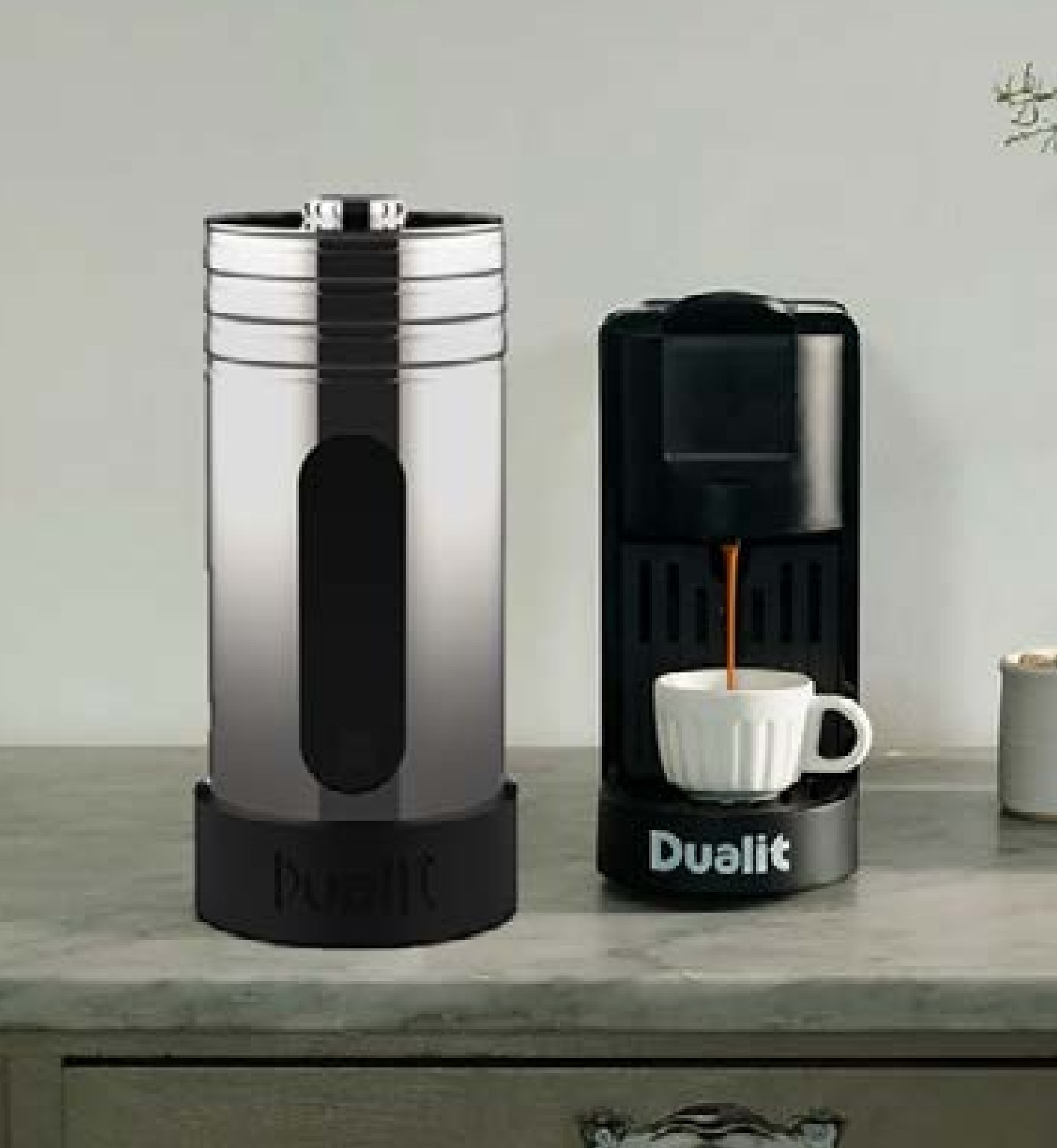Coffee station on a kitchen counter beside a black Dualit coffee machine